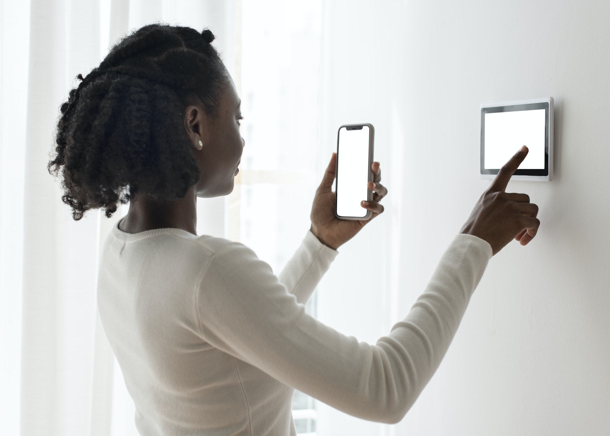 Woman pressing on smart home automation panel monitor